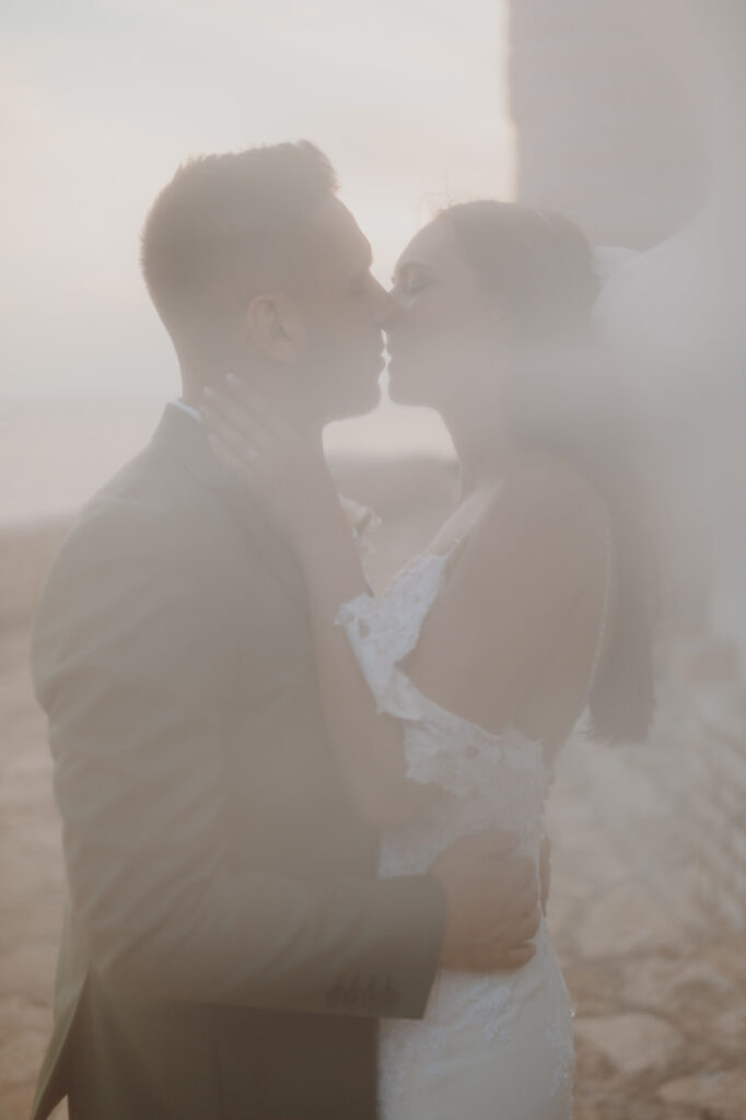 Newlyweds sharing a kiss in Novigrad, Istria