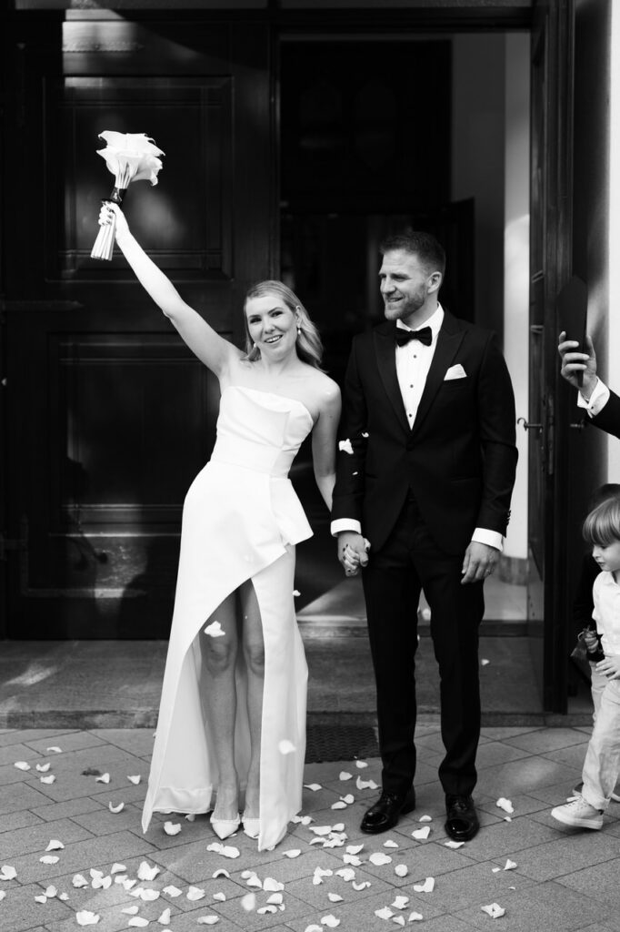Bride and groom exiting the church and celebrating.